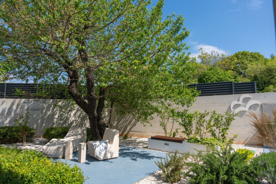 Spacious sun deck area with 6 comfortable deck chairs, a lounge corner, and stone-and-wood benches