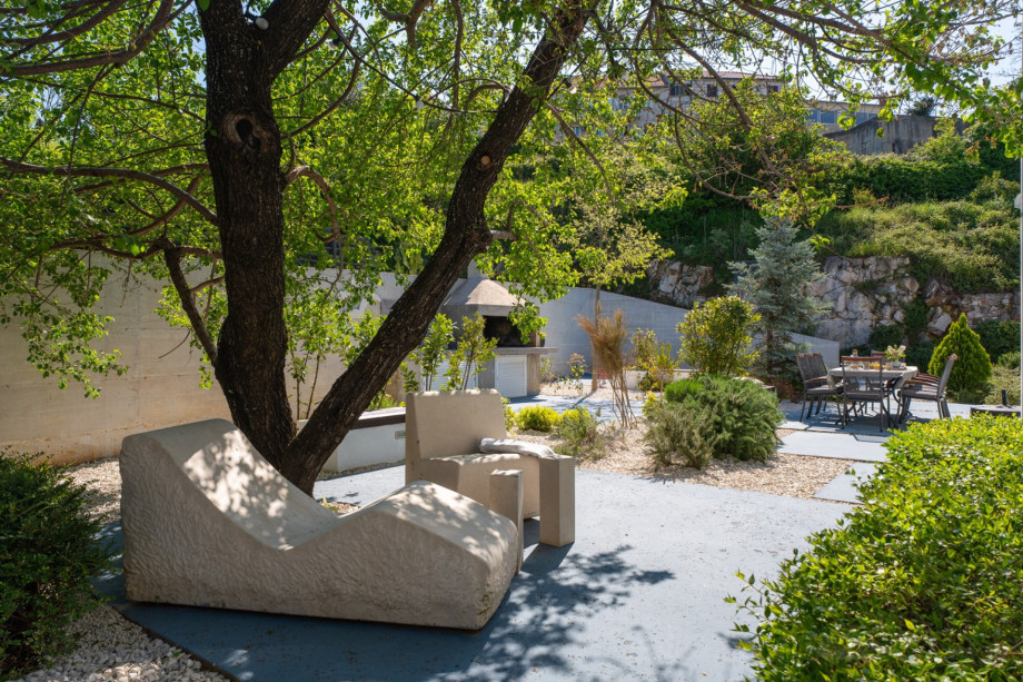 Spacious sun deck area with 6 comfortable deck chairs, a lounge corner, and stone-and-wood benches