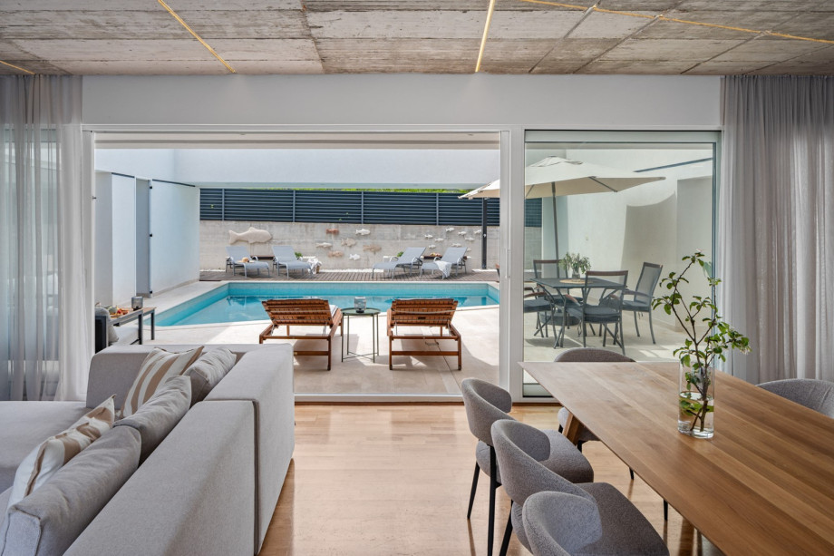 Sliding glass doors toward the outdoor dining area or toward the pool area makes this space more practical