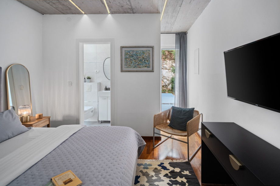 This bedroom has a glass door opening toward the garden, offering views and easy access to the outdoors