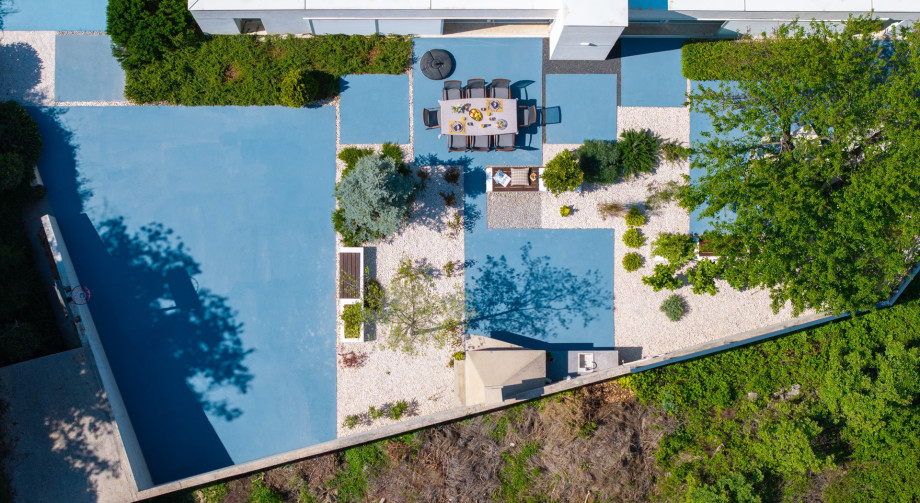 After swimming or playing, rinse off under the outdoor shower set amidst the peaceful garden, surrounded by natural beauty