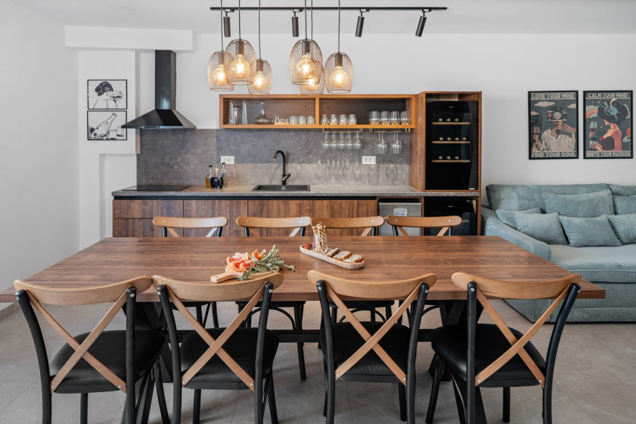 A fun zone with another kitchen and a dining table