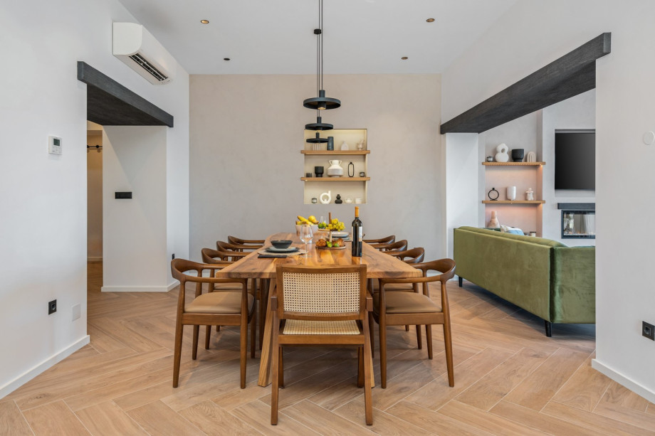 A wooden dining table for 8, sofas with flat screen TV, Netflix and HBO