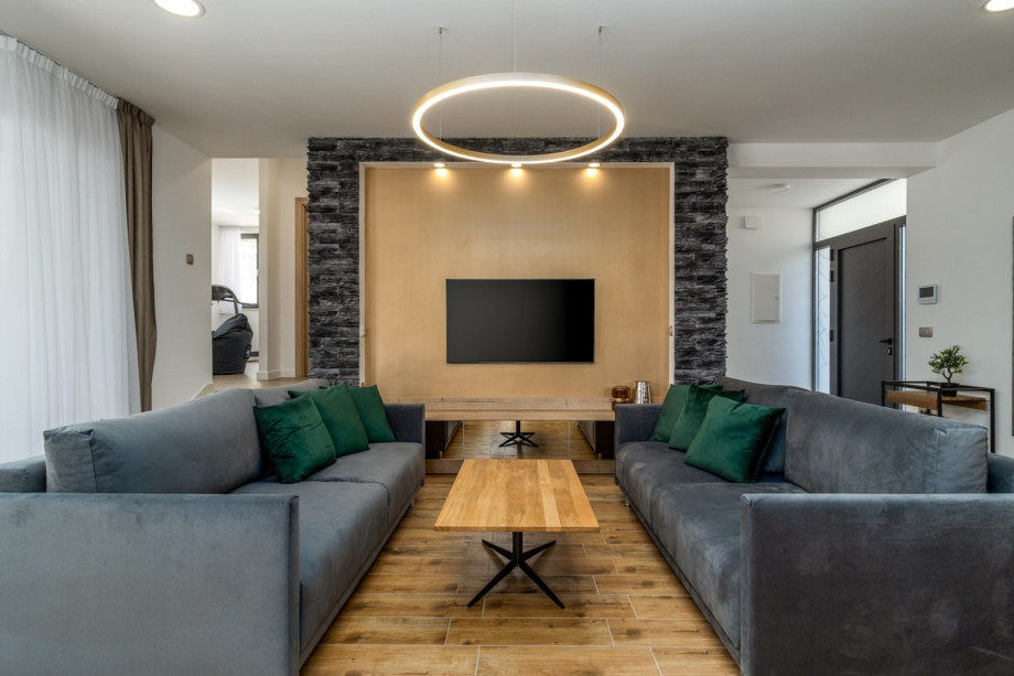 A spacious living room with a comfortable sofa and flat-screen TV