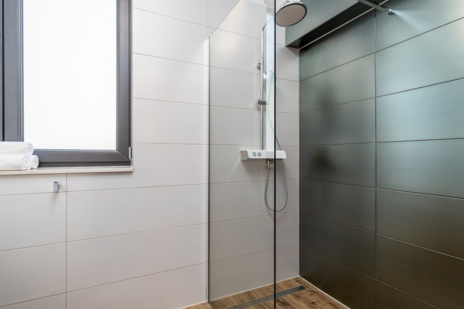 An en-suite bathroom with a shower, a sink, and a toilet