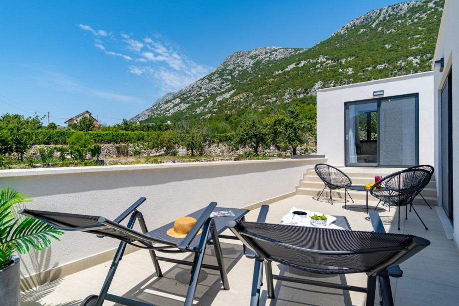 Bedroom No2 offers an exit to the terrace with a lounge corner