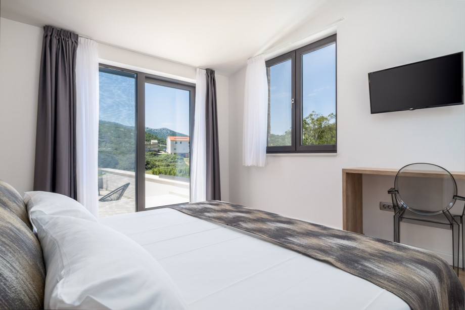 Bedroom No4 offers a TV, an A/C, and an exit to the terrace with a lounge corner