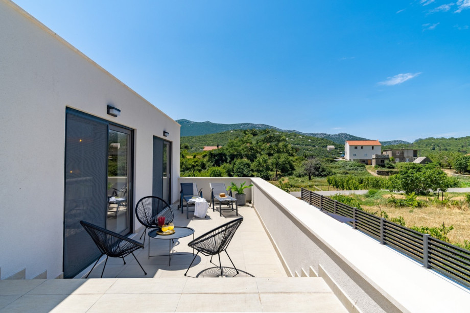 A terrace with a lounge corner; views of the pool and amazing natural surroundings