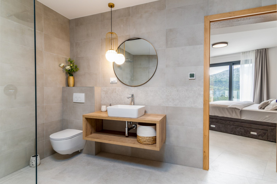 An en-suite bathroom with a bathtub, a shower, a sink, and a toilet