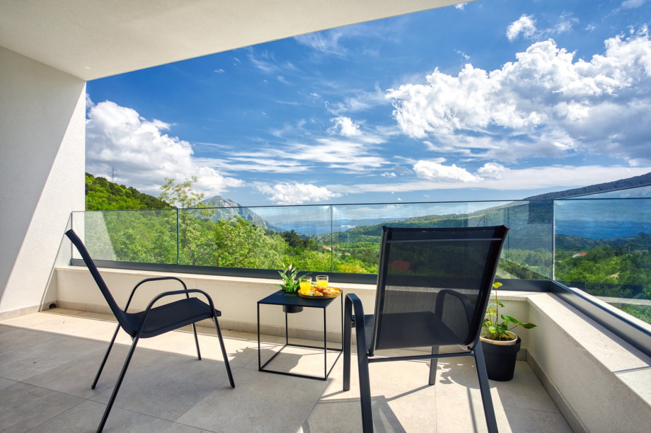 Bedroom No2 offers a large glass wall towards the terrace with a lounge corner