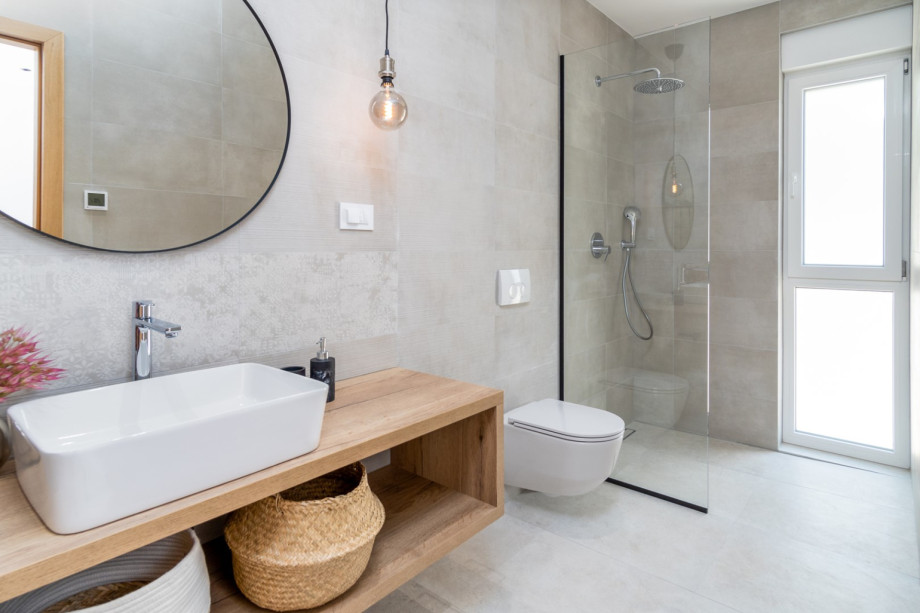An en-suite bathroom with a shower, a sink, and a toilet