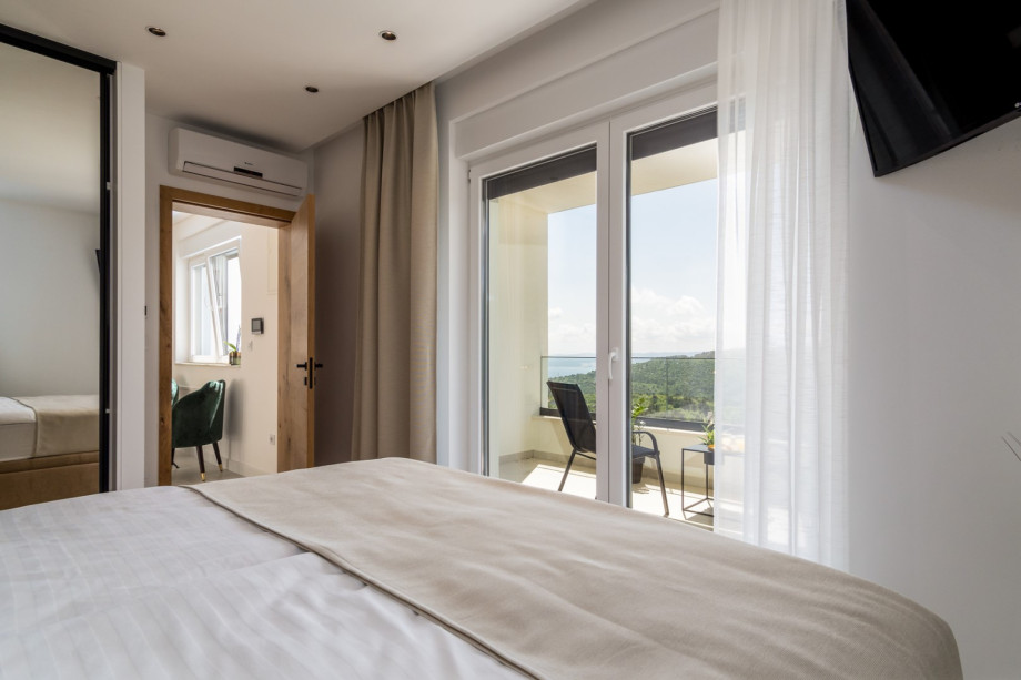 Bedroom No4 offers a large glass wall towards the terrace with a lounge corner