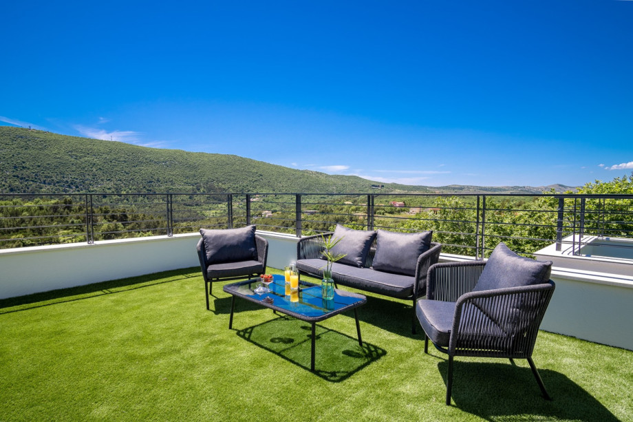 Bedroom No5 offers an exit to the terrace with lounge corner