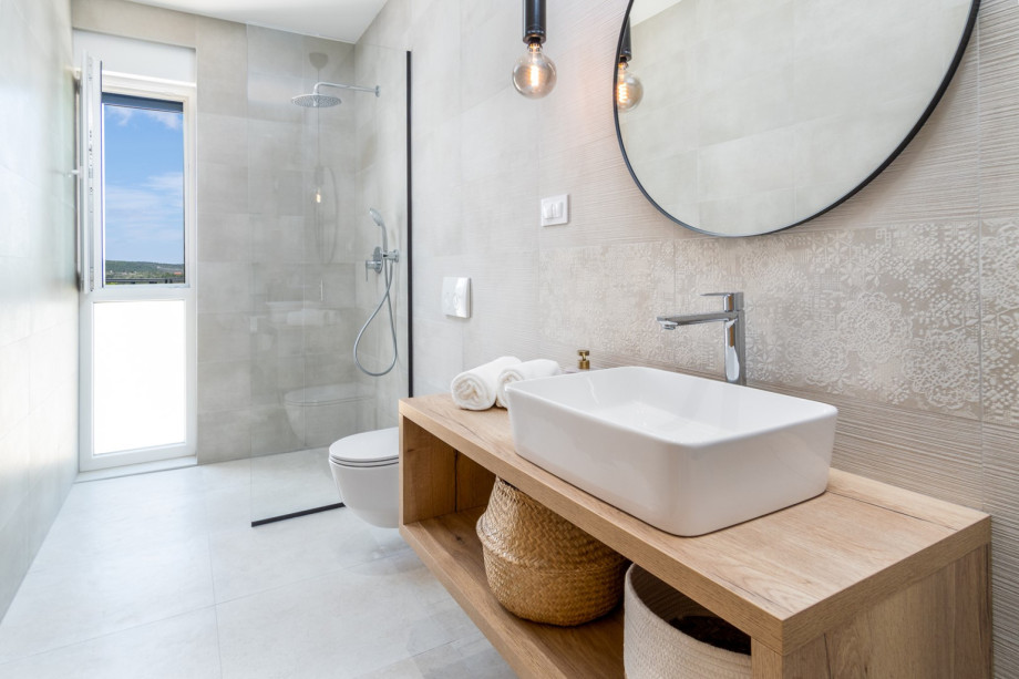 An en-suite bathroom with a shower, a sink, and a toilet