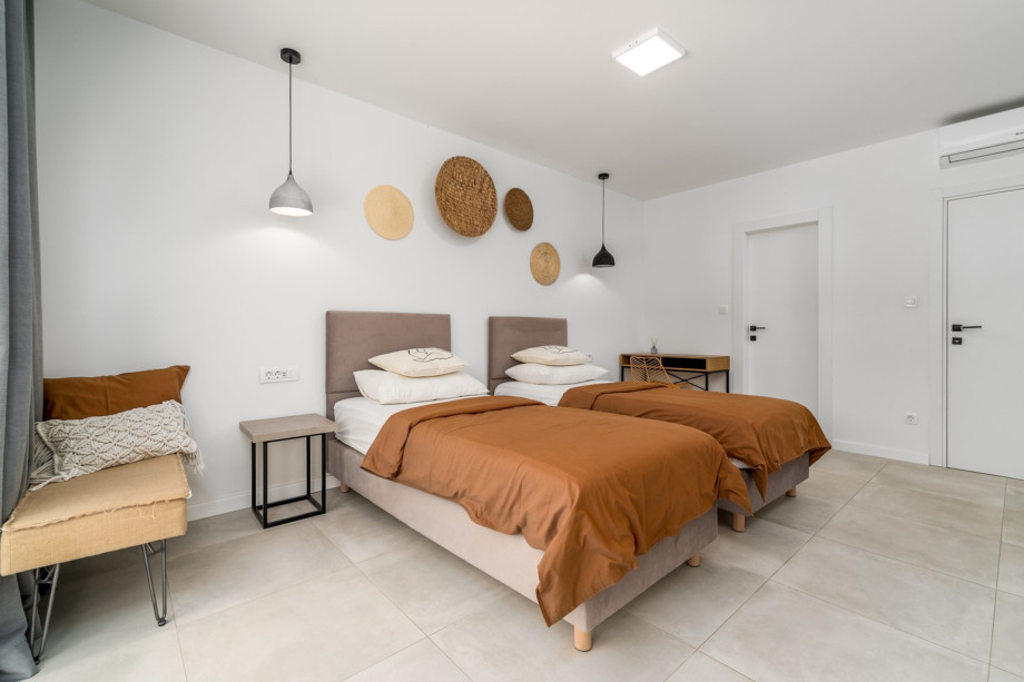 The first-floor offers a Bedroom No2 with 2 single beds and balcony with pool view.