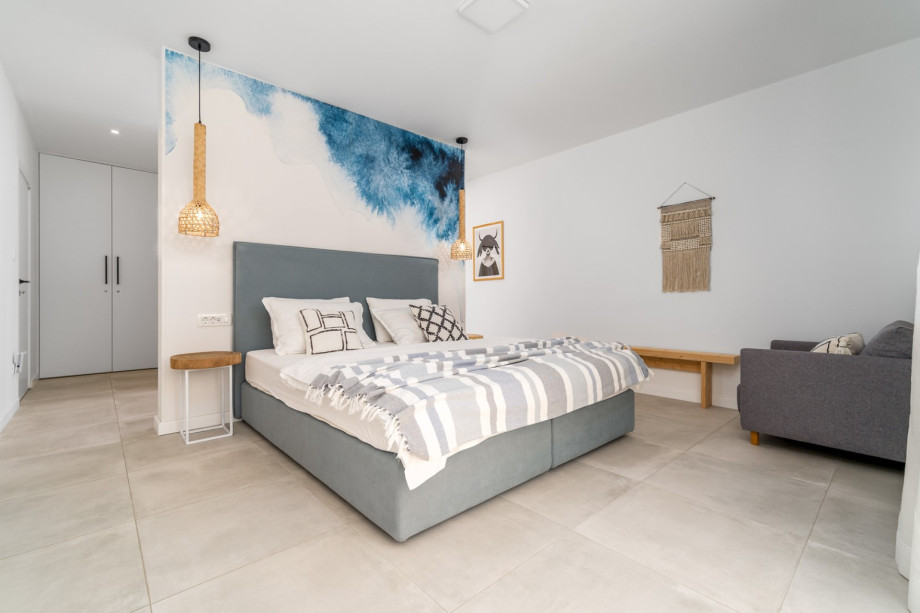 A Master Bedroom No 4 with king-size bed 180cm x 200cm, TV, A/C, ensuite bathroom with shower, a balcony with pool views.