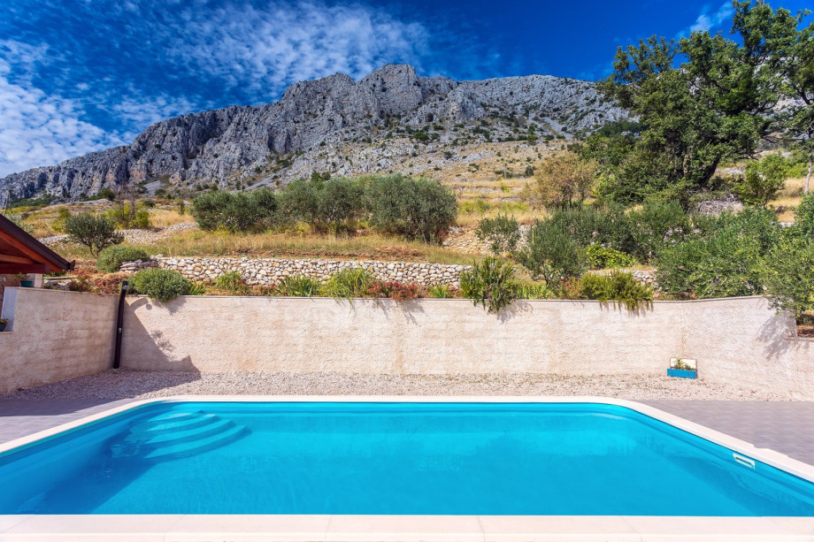 Pool is surrounded with nature and mountains