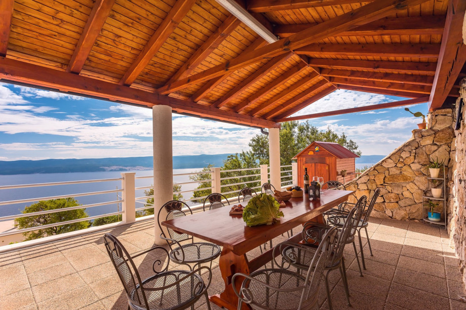 Outdoor dining area with wooden playhouse - next to the pool area