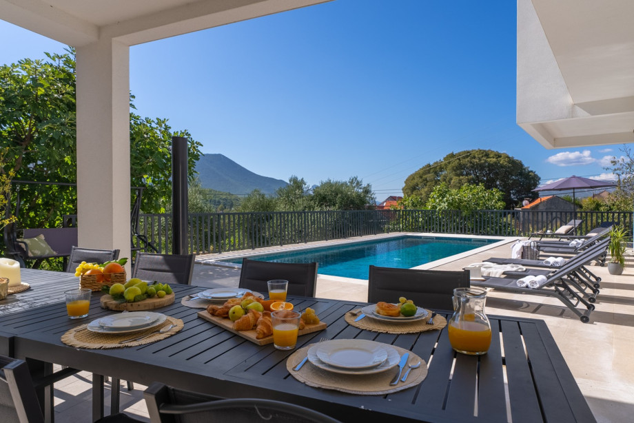 Relax and dine by the pool with stunning mountain views