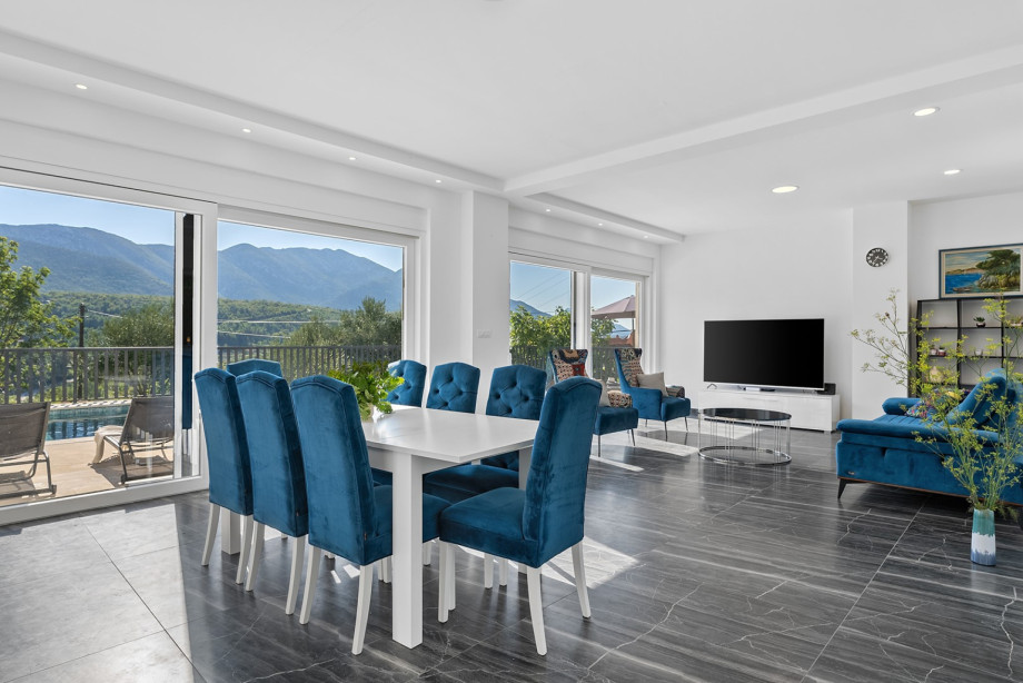 Spacious and stylish living room, featuring modern decor, plenty of natural light.