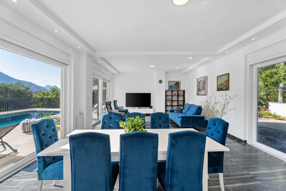 Elegant living room with air conditioning, couches, flat-screen TV