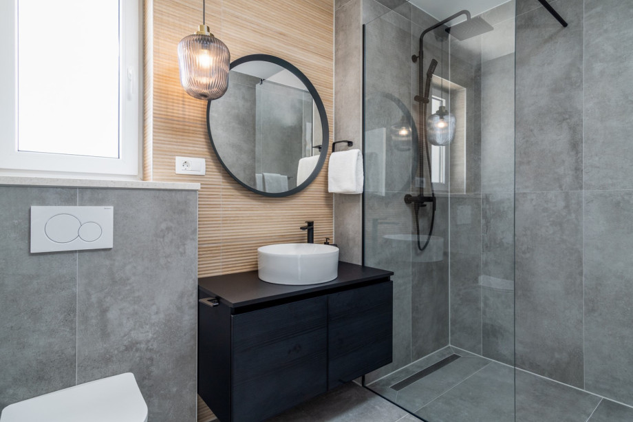 An en-suite bathroom with a shower, a toilet, and a sink