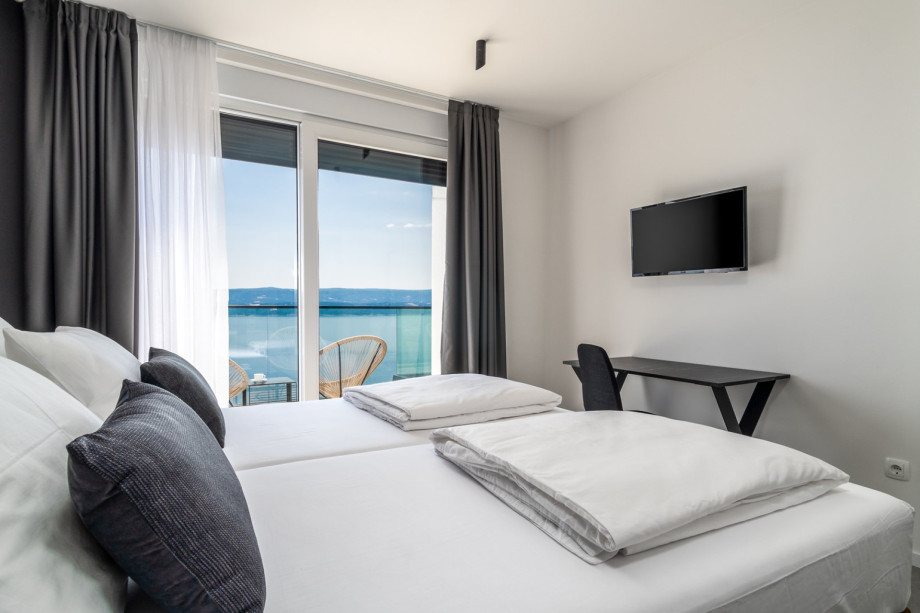 Bedroom No3 offers an en-suite bathroom with shower, TV, A/C, and balcony with sea views