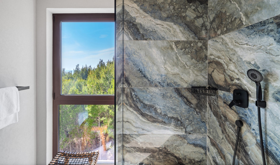 En-suite bathroom with a shower overlooking the sea
