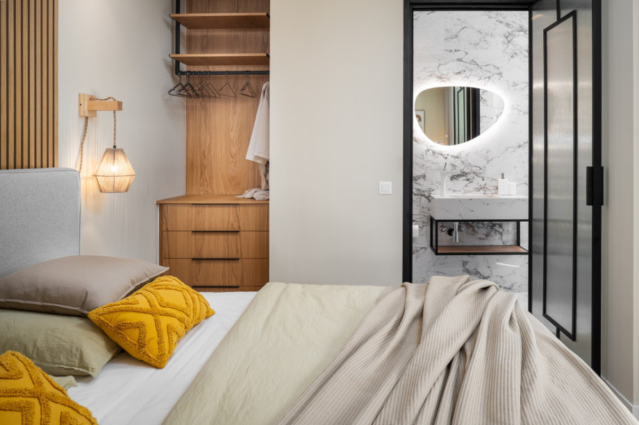 An en-suite bathroom with a shower, a sink, and a toilet