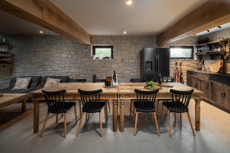 A fully functional retro kitchen, a ten-person wooden dining table, a flat-screen TV-equipped sofa, Air Hockey, table soccer, darts