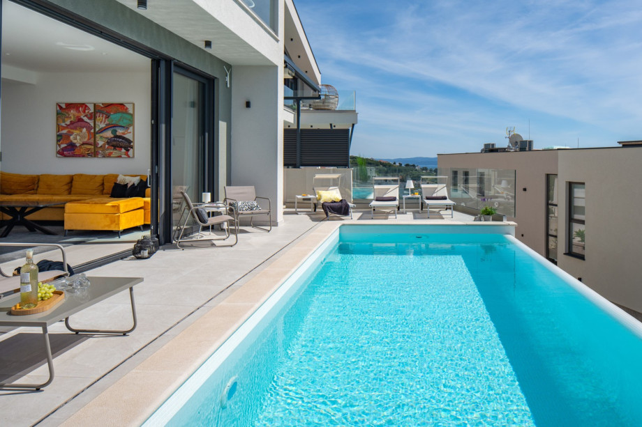 Floor to ceiling glass doors that seamlessly blend the living area