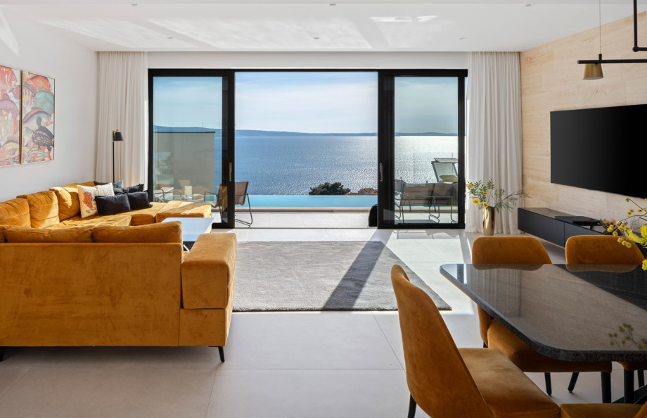 Living area complete with contemporary furnishings and large windows with sea view