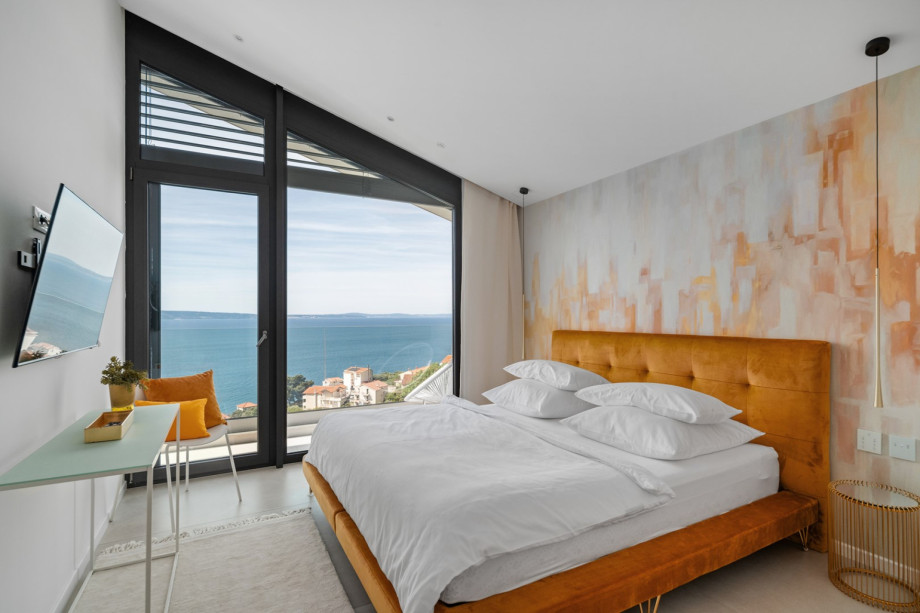 Bedroom NO3 with king-size bed and a balcony with views of the pool and sea