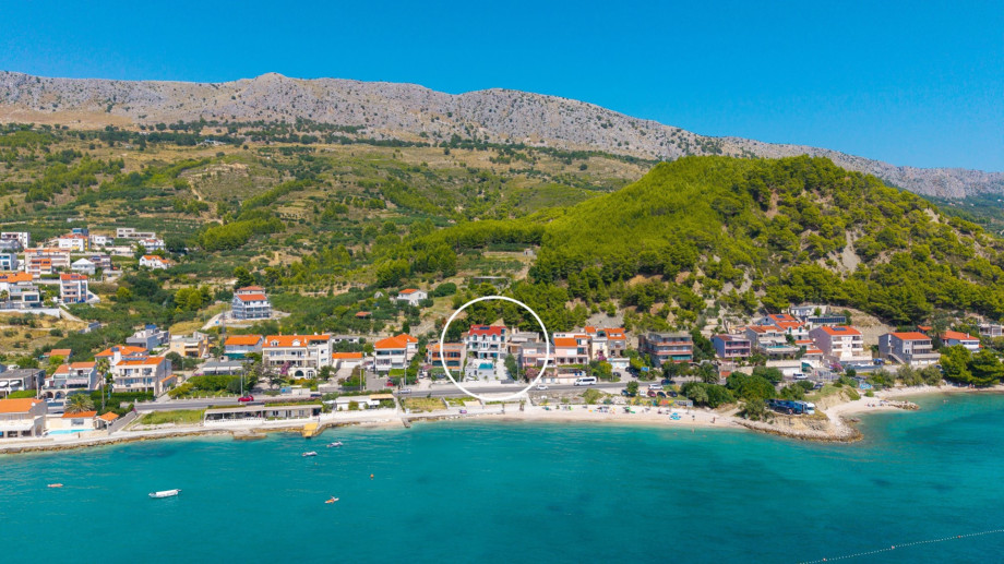 This exquisite property, located just 10 meters from the serene pebble beach