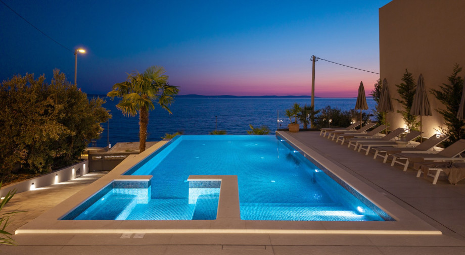 Unwinding by the pool at sunset with a stunning sea view – a moment that truly takes your breath away
