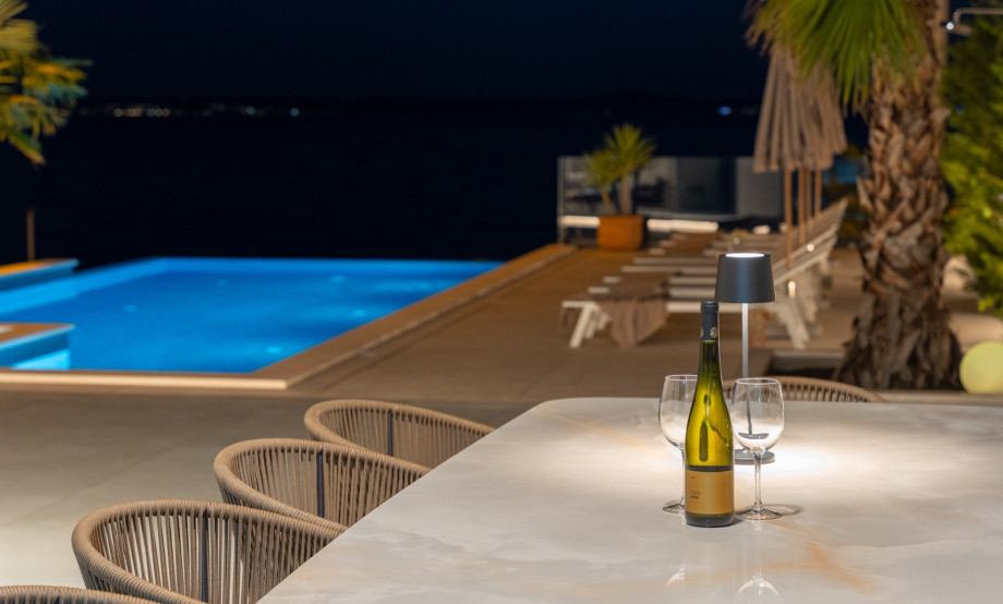 A perfect evening by the pool, drink in hand and the night all around.