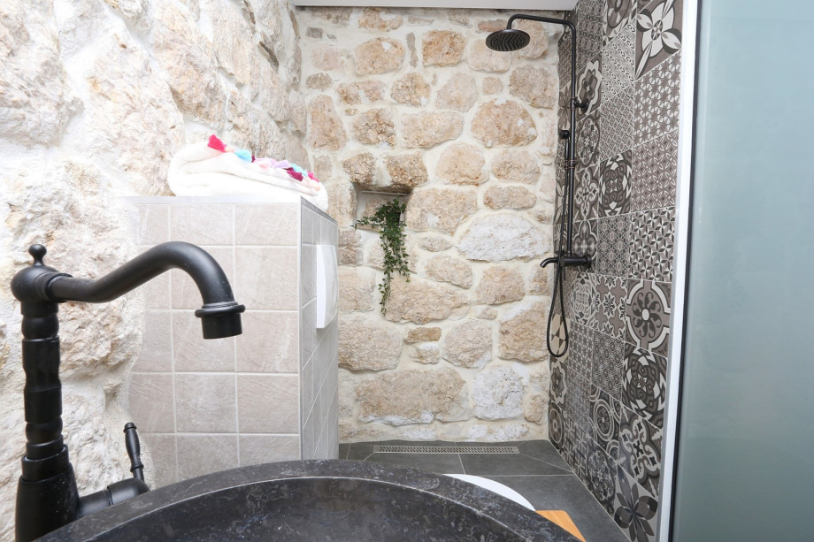 An en- suite bathroom with a shower, a toilet and a sink