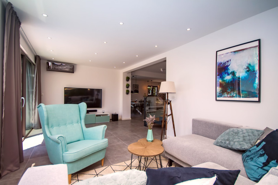 Living room connected with kitchen and dining area, exit to the pool