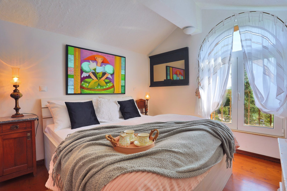 Bedroom on the first floor with a double bed and fantastic view on the pool area