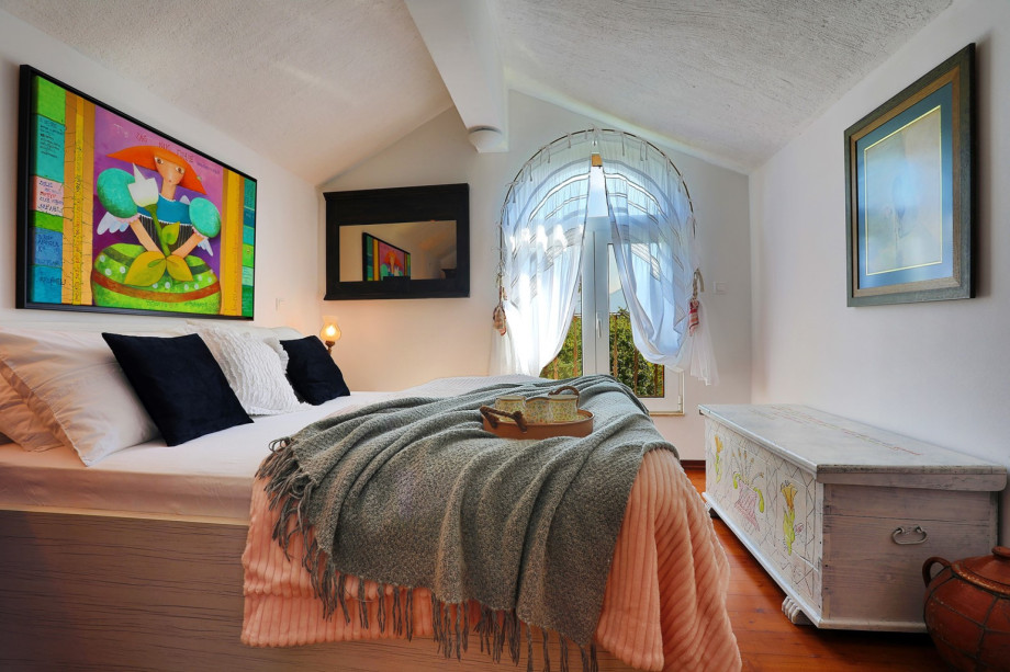 Bedroom on the first floor with a double bed and fantastic view on the pool area