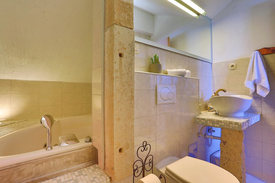 Bathroom on the 1st floor with a massage tub, shower and a toilet