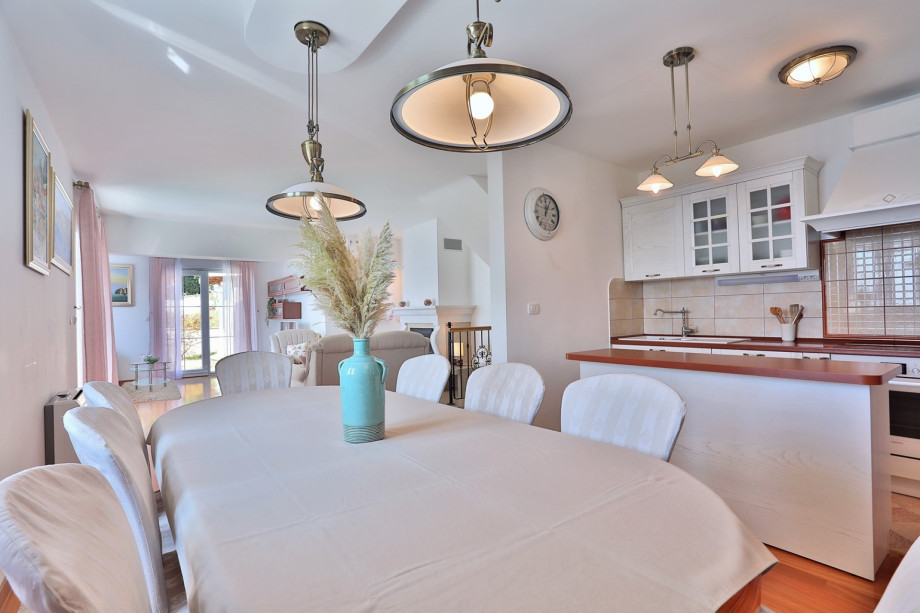 Spacious living area on the ground floor with TV, AC, and exit to the terrace.