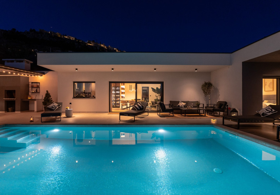 Private 8m x 4m pool with illuminating lights, adjacent to the charming lounge corner for relaxing in the evening.