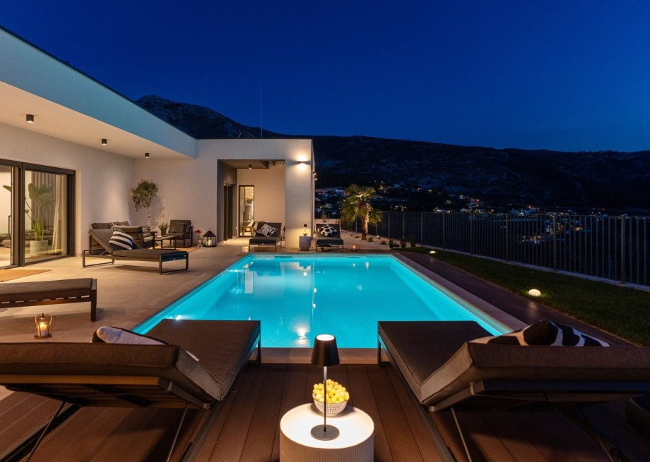The fully illuminated private 8m x 4m pool and sun terrace at night, perfect for a peaceful escape.