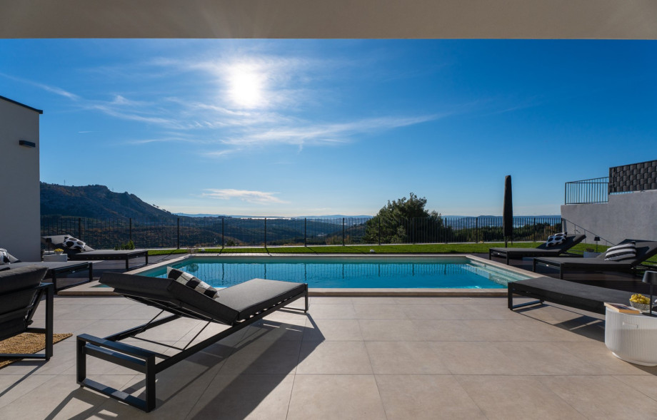 View of the inviting 8m x 4m hydro-massage pool set against a backdrop of mountains.