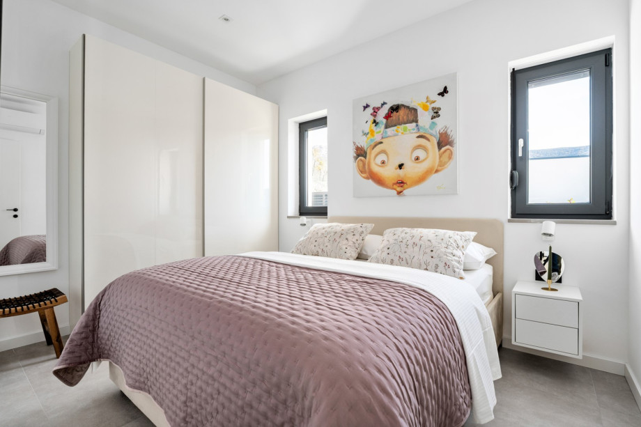 Bedroom 3 (10 sqm) featuring a cosy queen-size bed (160 cm x 200 cm), TV, and air-conditioning.