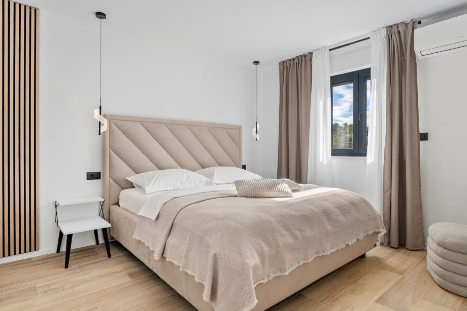 Bedroom 4 is a tastefully decorated space with a king-size bed and views of the natural surroundings.