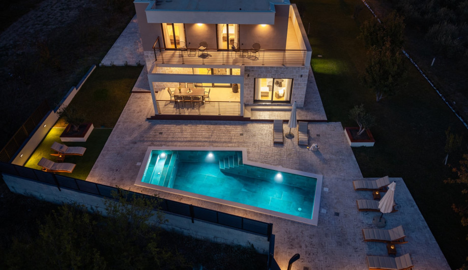 Evening ambience by the pool and covered outdoor dining area, perfect for sunset drinks and BBQ.