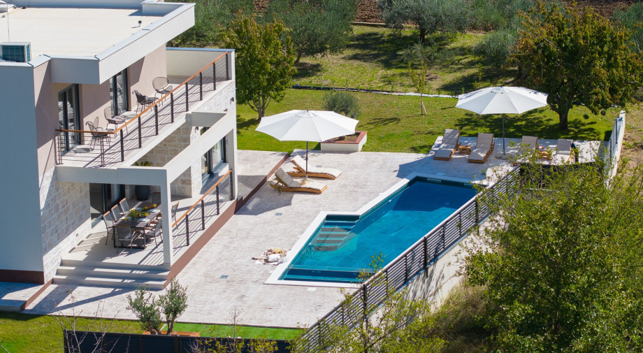 Relax by the 30 sqm private pool featuring hydromassage and a spacious sun deck with 10 loungers.