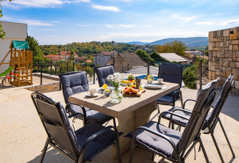 The elevated dining area provides a lovely spot for dining with views of the peaceful neighbourhood.